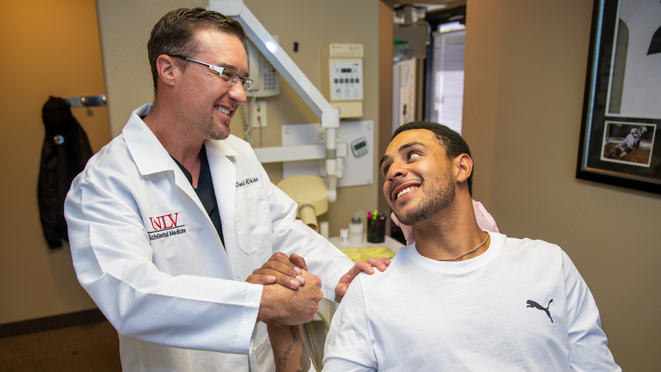 a doctor and a patient rejoicing after a successful dental procedure