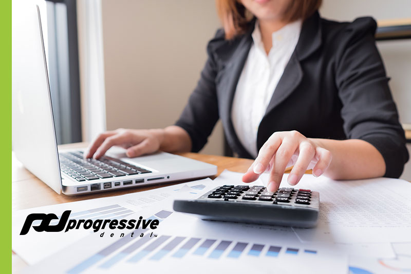 a dental assistant reconciling the financial accounts at a dental practice.